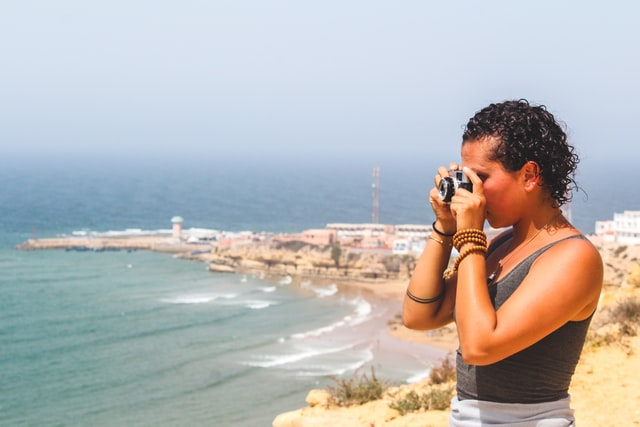 Woman taking a picture in morocco - Credit Louis hansel